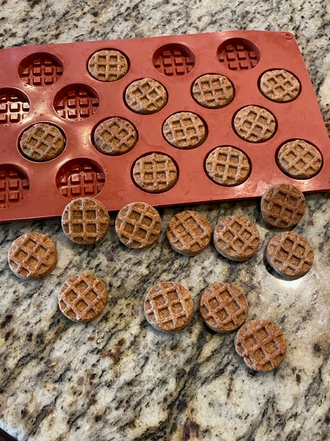  "Round waffle-shaped apple peanut butter dog treats handmade by Hello Katie Treats, shown with silicone baking mold"